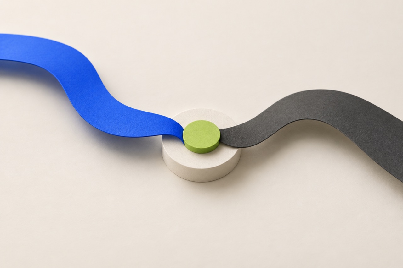 Blue and charcoal paper paths meet at one lime-green decision point, representing different perspectives finding a shared next step.